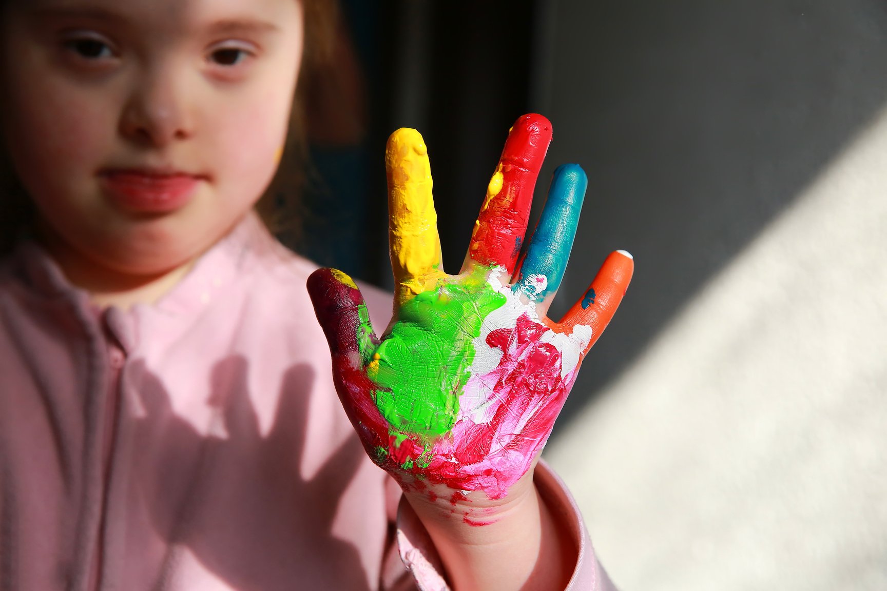 Painted Hand of a Girl with Down Syndrome